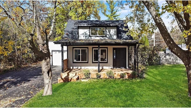 view of outdoor structure with a porch and a yard