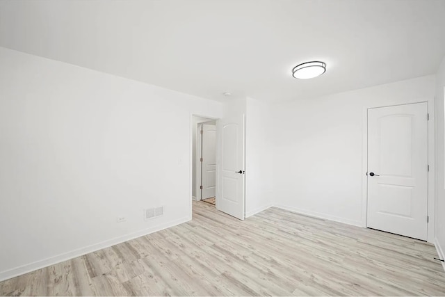 unfurnished room with light wood-type flooring