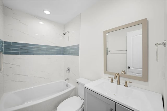 full bathroom featuring vanity, toilet, and tiled shower / bath combo