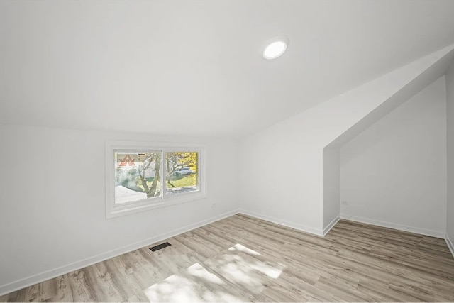 bonus room featuring light hardwood / wood-style floors and lofted ceiling