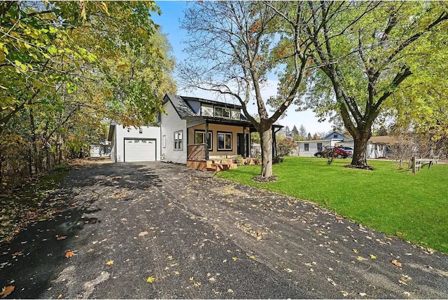 view of front of home featuring a front yard and a garage