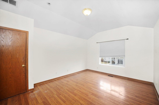 interior space with lofted ceiling and hardwood / wood-style flooring