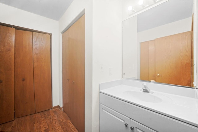 bathroom with hardwood / wood-style flooring and vanity