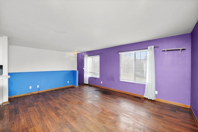 spare room with dark hardwood / wood-style floors