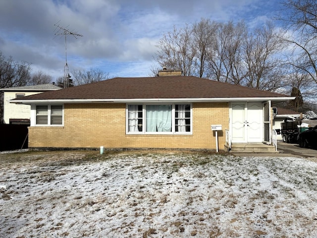 view of snow covered rear of property