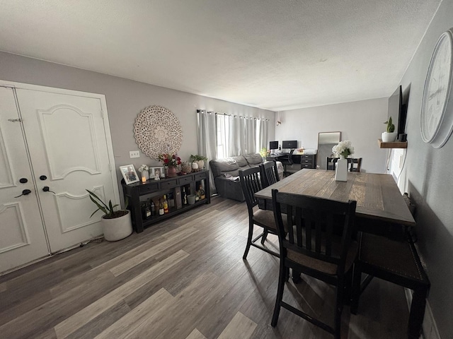 dining room featuring dark hardwood / wood-style floors and a textured ceiling