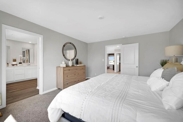 bathroom with hardwood / wood-style flooring, vanity, and a shower with shower door