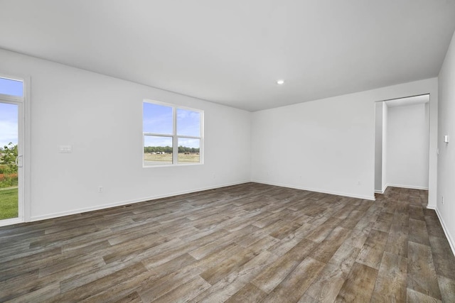 empty room with dark hardwood / wood-style floors