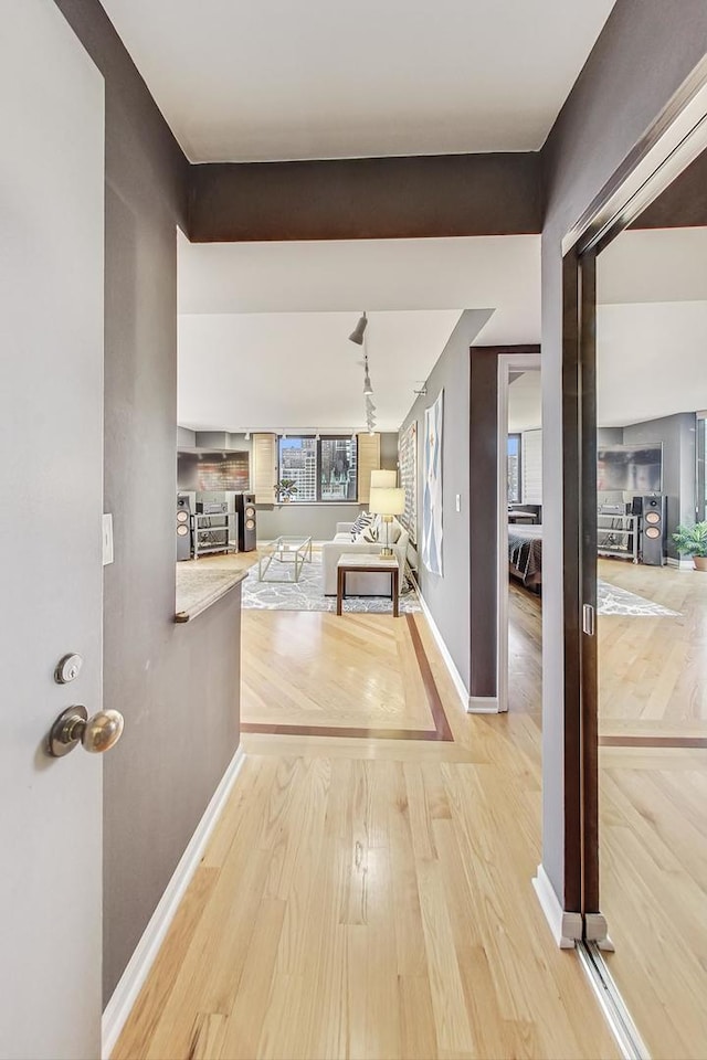 hallway with light hardwood / wood-style flooring