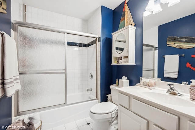 full bathroom featuring tile patterned flooring, vanity, toilet, and enclosed tub / shower combo