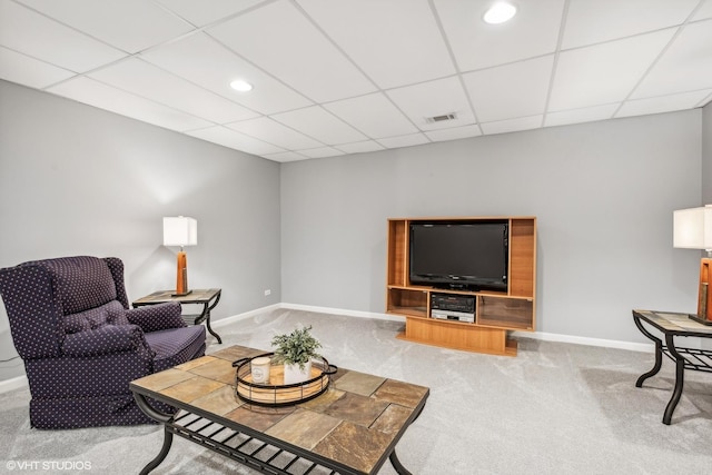 living room with carpet flooring and a paneled ceiling