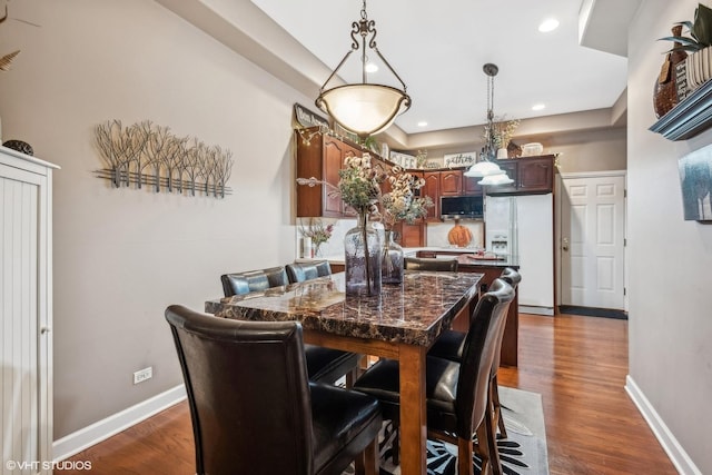 dining area with dark hardwood / wood-style flooring