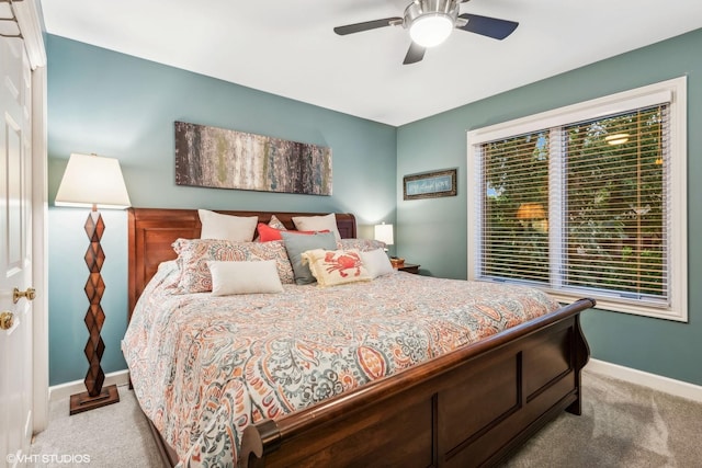 bedroom with light colored carpet and ceiling fan