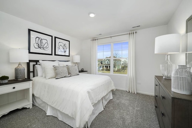 bedroom featuring dark colored carpet