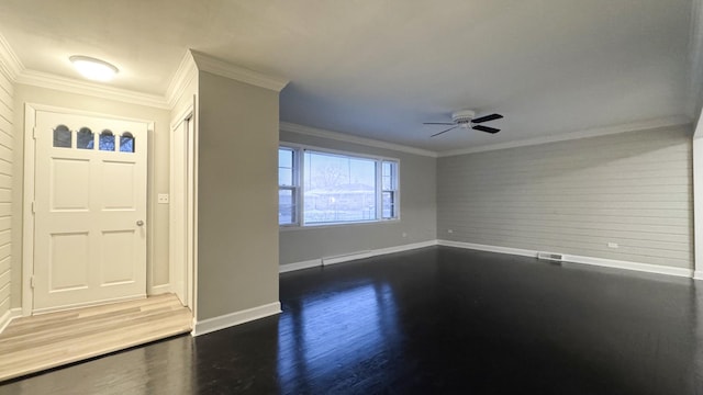 foyer featuring ceiling fan, ornamental molding, and dark wood-type flooring