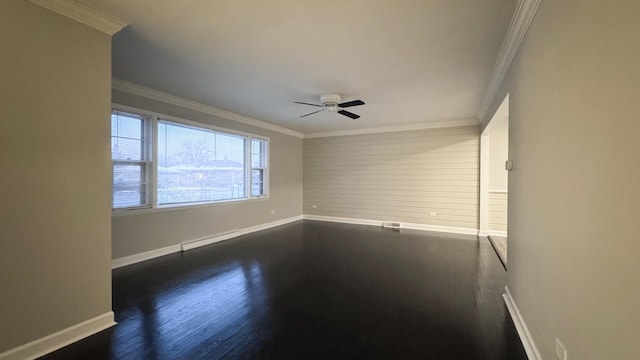 spare room featuring crown molding, dark hardwood / wood-style flooring, and ceiling fan