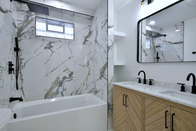 bathroom with tiled shower / bath combo and vanity