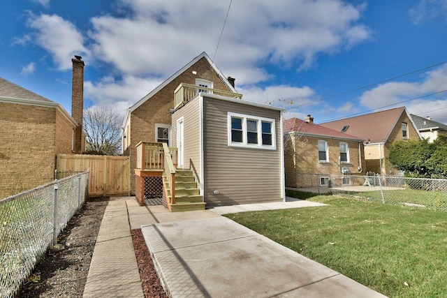 rear view of house with a lawn