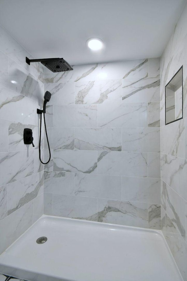 bathroom with tiled shower