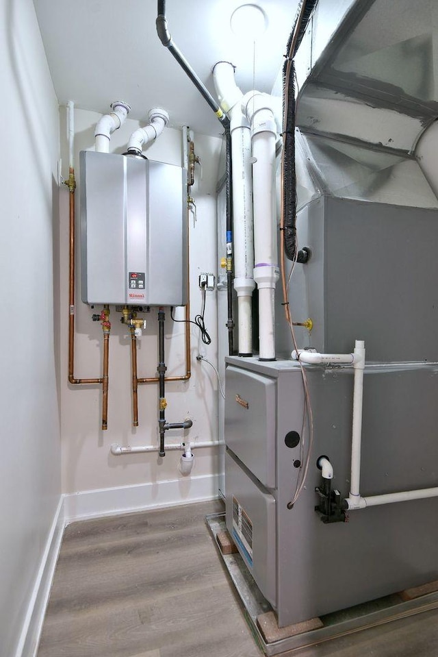 utility room featuring tankless water heater