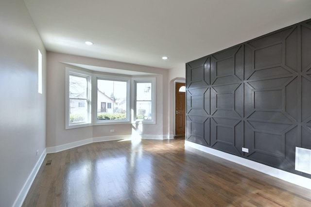 empty room featuring wood-type flooring