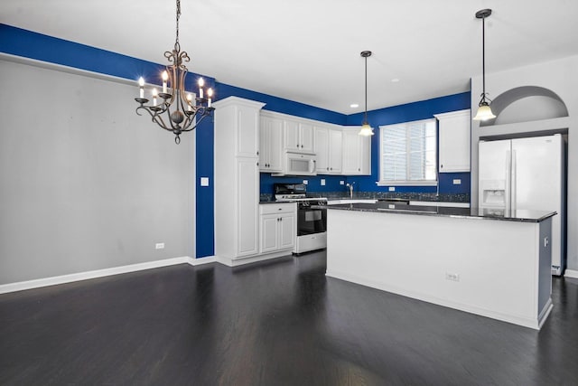 kitchen with a kitchen island, white appliances, white cabinetry, and pendant lighting