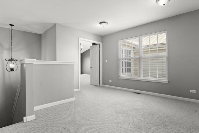 empty room featuring light colored carpet