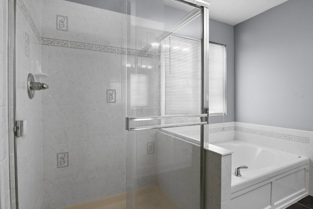 bathroom featuring a wealth of natural light, tile patterned floors, and independent shower and bath