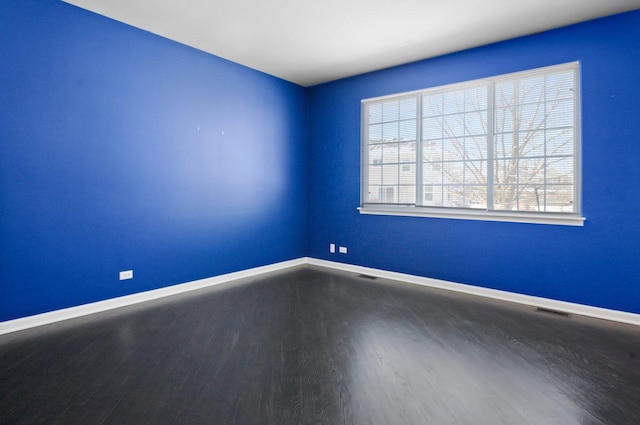 unfurnished room with hardwood / wood-style flooring