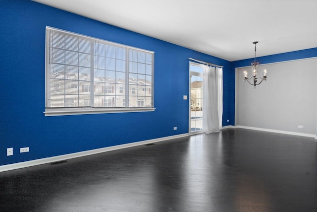 unfurnished room with an inviting chandelier and a wealth of natural light