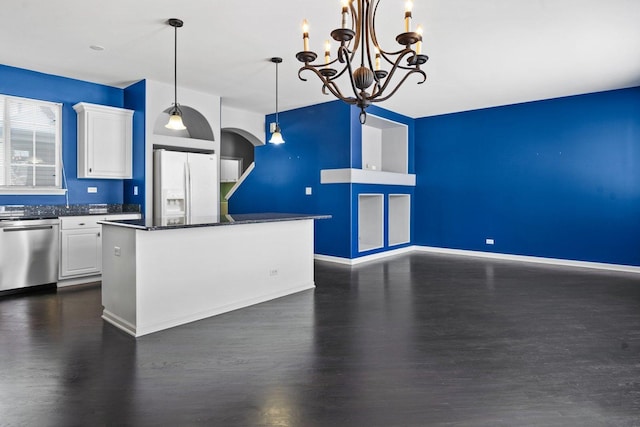 kitchen featuring dishwasher, pendant lighting, white refrigerator with ice dispenser, white cabinets, and a center island