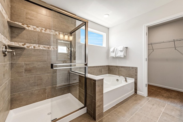 bathroom with tile patterned floors and separate shower and tub