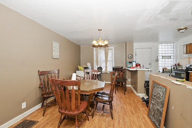 dining room featuring a chandelier and light hardwood / wood-style flooring