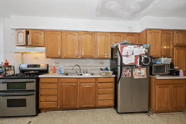 kitchen featuring sink, appliances with stainless steel finishes, and tasteful backsplash