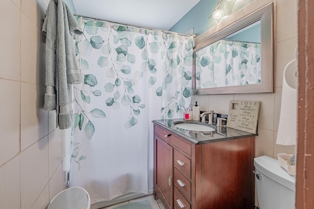 full bathroom featuring shower / bath combination with curtain, vanity, toilet, and tile walls