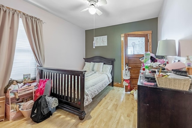 bedroom with ceiling fan and light wood-type flooring