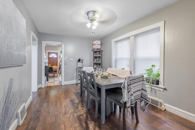 dining space with plenty of natural light, ceiling fan, and dark wood-type flooring