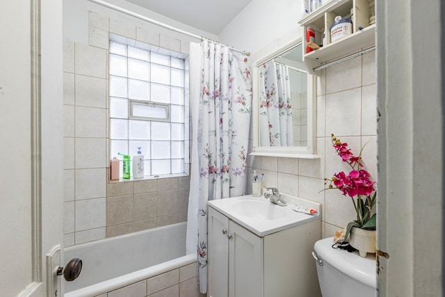 full bathroom with vanity, a healthy amount of sunlight, shower / tub combo, and toilet