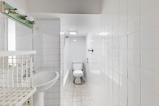 bathroom featuring curtained shower, tile patterned flooring, tile walls, and toilet