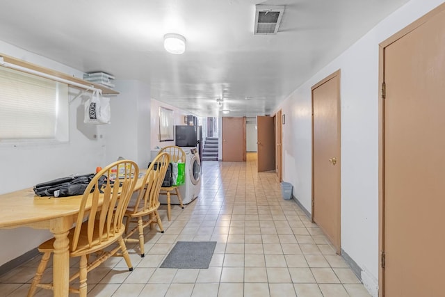 tiled dining space with washer and dryer