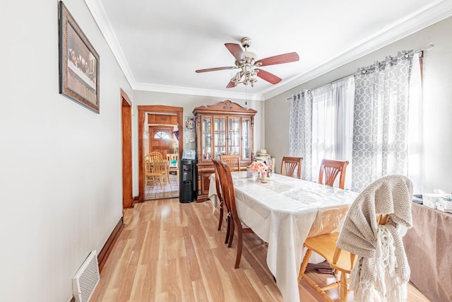 dining space featuring light hardwood / wood-style flooring, ceiling fan, and crown molding