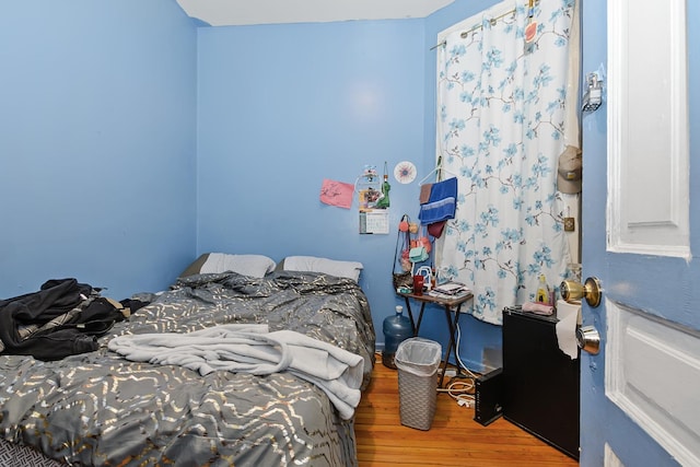 bedroom with hardwood / wood-style flooring