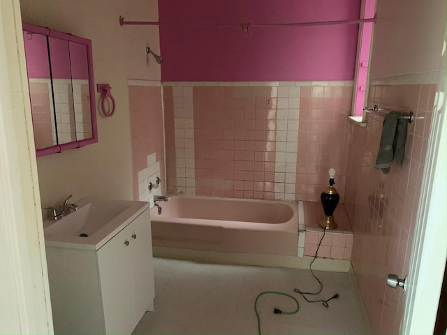 bathroom with a bathing tub and vanity