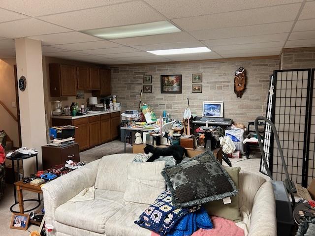 living room featuring a paneled ceiling