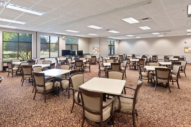 dining area with a drop ceiling