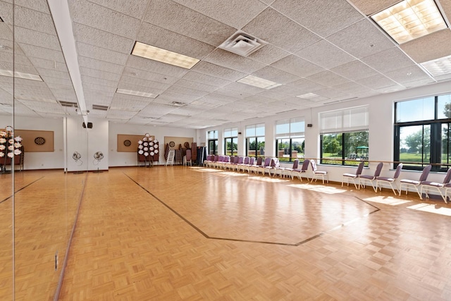 interior space featuring parquet floors and a drop ceiling