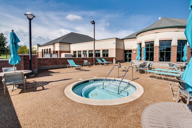 view of pool with a community hot tub and a patio area