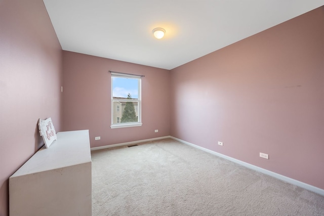 unfurnished room featuring light carpet