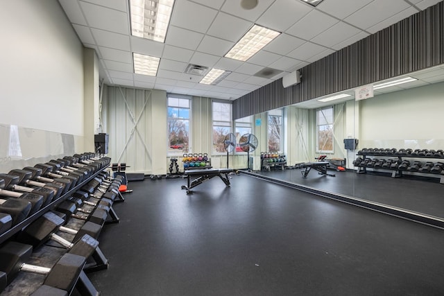 gym with a paneled ceiling