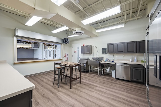 kitchen with dishwasher and light hardwood / wood-style floors